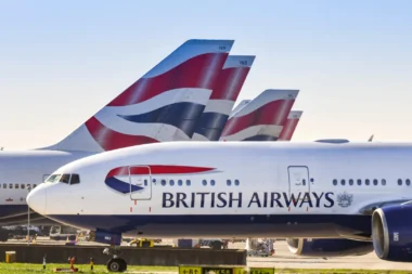 Das von British Airways betriebene Langstreckenflugzeug Boeing 777 rollt für den Start an den Heckflossen der anderen Flugzeuge des Unternehmens vorbei.